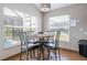 Eat in kitchen dining area with backyard pool view and a sleek, modern chandelier at 8102 Pomo Dr, Kissimmee, FL 34747