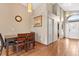 Bright dining room boasts a modern light fixture, wood flooring and a 'Bless This Home' decoration at 8102 Pomo Dr, Kissimmee, FL 34747