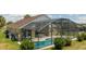Back exterior view of the home, pool, and screened-in patio at 8102 Pomo Dr, Kissimmee, FL 34747