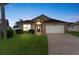 Charming single-story home with well-maintained lawn, attached garage, and appealing curb appeal at 8102 Pomo Dr, Kissimmee, FL 34747