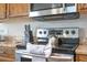 Detailed look at the stainless steel stove and microwave with tile countertops in this eat-in kitchen at 8102 Pomo Dr, Kissimmee, FL 34747