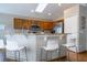 Eat-in kitchen features an island with a bar, stainless steel appliances, and ample cabinet space at 8102 Pomo Dr, Kissimmee, FL 34747