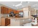 Kitchen features a breakfast bar, stainless appliances, wooden cabinets, and a skylight at 8102 Pomo Dr, Kissimmee, FL 34747