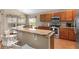 An eat-in kitchen includes wood cabinets, stainless steel appliances, and a tile countertop at 8102 Pomo Dr, Kissimmee, FL 34747
