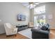 Living room features vaulted ceilings, large windows, ceiling fan, and a comfortable seating area at 8102 Pomo Dr, Kissimmee, FL 34747