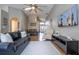 Open living space with wood floors, comfortable seating, and view of dining area at 8102 Pomo Dr, Kissimmee, FL 34747