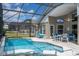 Screened-in pool and patio area with outdoor seating and a TV at 8102 Pomo Dr, Kissimmee, FL 34747