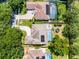 Aerial view showcasing the home's layout, backyard pool, solar panels, and driveway with mature landscaping at 8122 Westminster Abbey Blvd, Orlando, FL 32835
