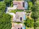 Aerial view showcasing the home's layout, backyard pool, solar panels, and driveway with mature landscaping at 8122 Westminster Abbey Blvd, Orlando, FL 32835