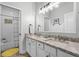 Bright bathroom with a double sink vanity, large mirror, and a separate toilet and shower room at 8122 Westminster Abbey Blvd, Orlando, FL 32835