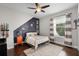 Stylish bedroom design featuring hardwood floors, ceiling fan and playful wall decor at 8122 Westminster Abbey Blvd, Orlando, FL 32835