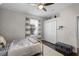 Cozy bedroom features hardwood floors, ceiling fan, striped curtains, and a closet at 8122 Westminster Abbey Blvd, Orlando, FL 32835