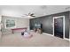 Spacious bonus room includes an accent wall, neutral carpet, and natural light from a window at 8122 Westminster Abbey Blvd, Orlando, FL 32835