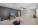 Spacious bonus room includes an accent wall, neutral carpet, and natural light from a window at 8122 Westminster Abbey Blvd, Orlando, FL 32835