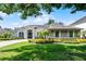 Well-manicured front exterior of a gray single-story home with a beautiful lawn and landscaping at 8122 Westminster Abbey Blvd, Orlando, FL 32835