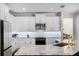 Well-lit kitchen with white cabinets, stainless steel appliances, and modern finishes at 8122 Westminster Abbey Blvd, Orlando, FL 32835