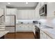 Kitchen featuring white cabinets, modern appliances, and stylish countertops at 8122 Westminster Abbey Blvd, Orlando, FL 32835