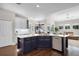 The kitchen features dark blue cabinets, stainless steel appliances, and marble countertops at 8122 Westminster Abbey Blvd, Orlando, FL 32835