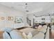 Open-concept living room showcasing a kitchen with an island and comfortable seating area at 8122 Westminster Abbey Blvd, Orlando, FL 32835