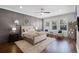 Stylish main bedroom with a neutral color palette, wood-paneled wall, and large windows at 8122 Westminster Abbey Blvd, Orlando, FL 32835