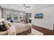 Spacious main bedroom featuring hardwood floors, a ceiling fan and lots of natural light at 8122 Westminster Abbey Blvd, Orlando, FL 32835