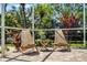 Cozy patio with two wooden chairs, a small table, and potted plants, creating a relaxing outdoor space at 8122 Westminster Abbey Blvd, Orlando, FL 32835
