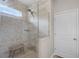 Modern shower featuring tiled walls, a glass enclosure, and a built-in shelf at 8122 Westminster Abbey Blvd, Orlando, FL 32835