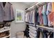 Organized walk-in closet with shelving, storage, and a window bringing in natural light at 8122 Westminster Abbey Blvd, Orlando, FL 32835