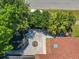 Aerial view showcases a backyard with a circular feature, patio, and mature trees at 8346 Mattituck Cir, Orlando, FL 32829