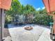 Wide shot of backyard featuring a trampoline, brick fire pit, and lush landscaping at 8346 Mattituck Cir, Orlando, FL 32829