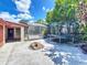 Large backyard with brick fire pit, trampoline, screened pool, and lush greenery at 8346 Mattituck Cir, Orlando, FL 32829