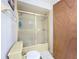 Bathroom features shower with sliding doors, beige tiled walls, and toilet at 8346 Mattituck Cir, Orlando, FL 32829