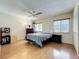 Bedroom with wood floors, natural lighting, ceiling fan, and comfortable bed at 8346 Mattituck Cir, Orlando, FL 32829
