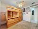 Bedroom with carpeted floors, ceiling fan, lofted bed with integrated storage and desk at 8346 Mattituck Cir, Orlando, FL 32829