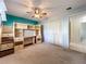 Bedroom with carpeted floors, lofted bed with desk and storage, and view of tile flooring in hallway at 8346 Mattituck Cir, Orlando, FL 32829