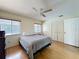 Bedroom features wood floors, comfortable bed, ample closet space, and natural lighting at 8346 Mattituck Cir, Orlando, FL 32829