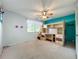 Bedroom featuring carpeted floors, lofted bed with desk and storage, and natural light at 8346 Mattituck Cir, Orlando, FL 32829