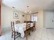 Bright dining area offers tiled floors, a chandelier and a view of the backyard at 8346 Mattituck Cir, Orlando, FL 32829