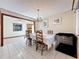 Dining room features elegant chandelier, tiled floors and transitions into the kitchen at 8346 Mattituck Cir, Orlando, FL 32829