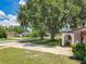 Exterior view of a home with mature trees providing shade at 8346 Mattituck Cir, Orlando, FL 32829