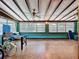 Bright Florida room with a paneled ceiling, vintage floors, and lots of natural light from the large windows at 8346 Mattituck Cir, Orlando, FL 32829