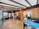 View of Florida Room features wood-paneled walls, beamed ceilings, and a vintage brick floor at 8346 Mattituck Cir, Orlando, FL 32829