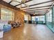 Relaxing Florida room features wood paneling, beamed ceilings, and a vintage brick floor at 8346 Mattituck Cir, Orlando, FL 32829