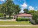 Charming front yard with a well-maintained lawn, lovely landscaping, and beautiful shade tree at 8346 Mattituck Cir, Orlando, FL 32829