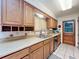 Traditional kitchen featuring oak cabinets, neutral countertops, stainless steel appliances, and a double sink at 8346 Mattituck Cir, Orlando, FL 32829