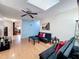 Cozy living area showcasing skylight, modern furnishings, wood floors, and a bright, airy ambiance at 8346 Mattituck Cir, Orlando, FL 32829