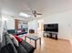 Comfortable living space featuring a skylight, modern seating, wood floors, and an open layout at 8346 Mattituck Cir, Orlando, FL 32829