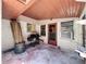 Outdoor patio features vintage brick, grill, firewood, and easy access to the house at 8346 Mattituck Cir, Orlando, FL 32829