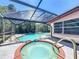 Relax in this private outdoor oasis featuring a screened pool and spa with brick trim at 8346 Mattituck Cir, Orlando, FL 32829