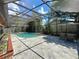 Sparkling screened pool with surrounding patio and lush landscaping in the backyard at 8346 Mattituck Cir, Orlando, FL 32829